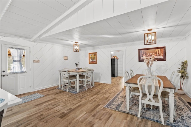 dining room featuring wood ceiling, wood finished floors, beam ceiling, and baseboards