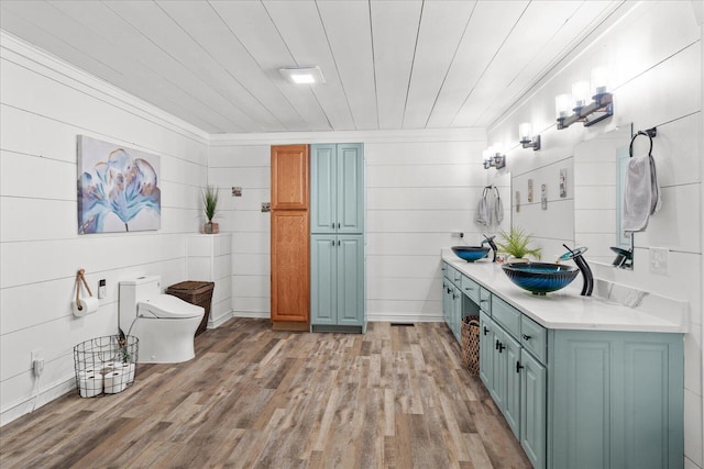 bathroom with wood ceiling, a sink, toilet, and wood finished floors