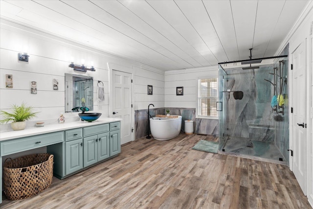 bathroom featuring a soaking tub, wood ceiling, a shower stall, vanity, and wood finished floors