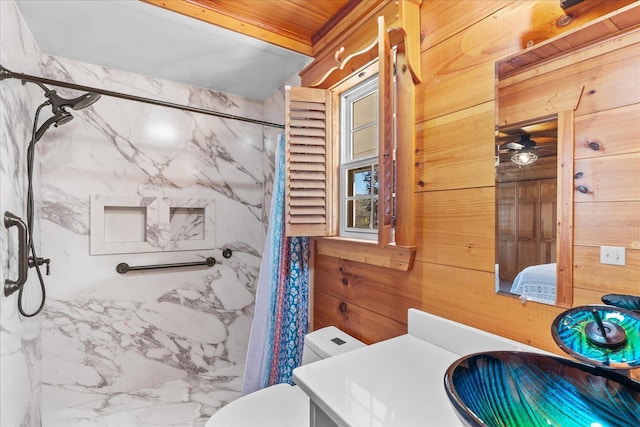 full bathroom featuring vanity, a marble finish shower, and toilet