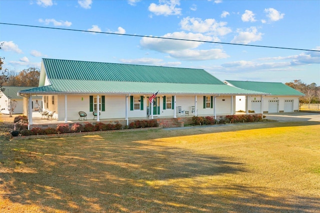 farmhouse featuring metal roof, a porch, and a front yard