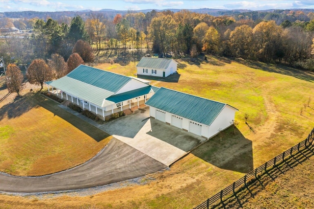 drone / aerial view with a forest view and a rural view