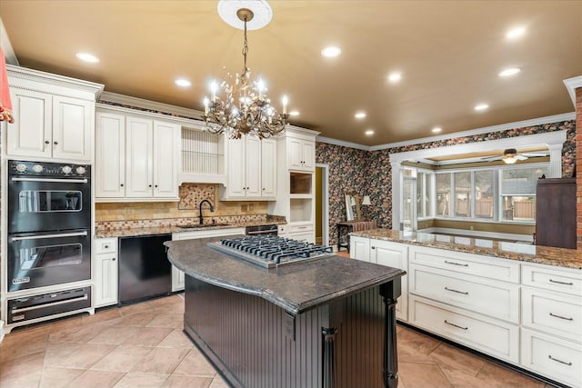 kitchen featuring sink, white cabinetry, decorative light fixtures, a kitchen island, and black appliances