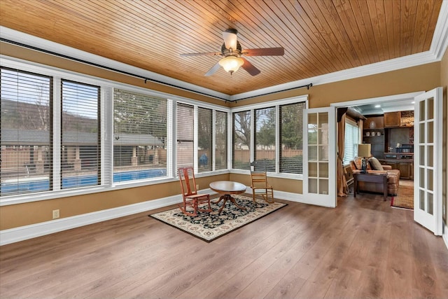 sunroom with wood ceiling, ceiling fan, plenty of natural light, and french doors