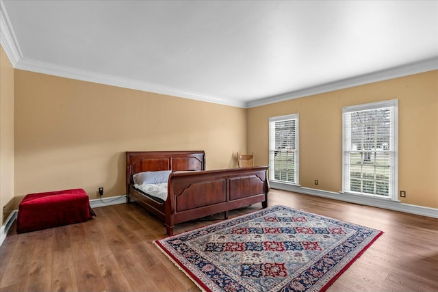 bedroom with crown molding and hardwood / wood-style floors