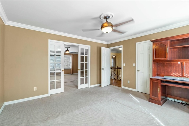 unfurnished office with french doors, ceiling fan, ornamental molding, and light carpet