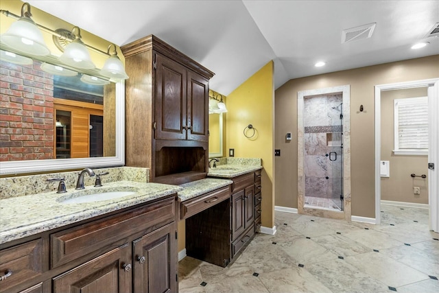 bathroom with vanity and a shower with shower door