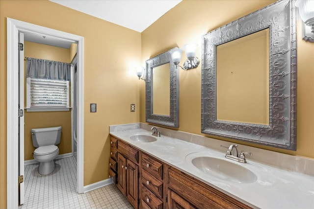 bathroom featuring tile patterned flooring, vanity, and toilet