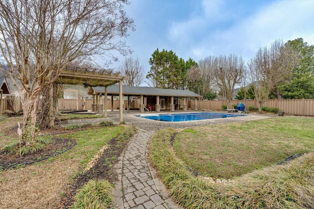 view of pool with a yard and a pergola