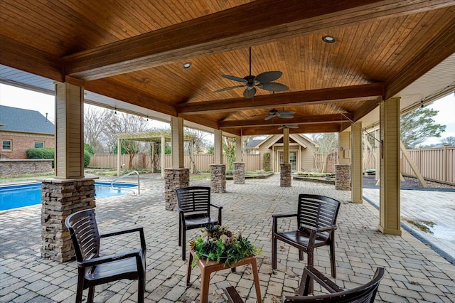 view of patio / terrace featuring a fenced in pool, an outdoor structure, and ceiling fan