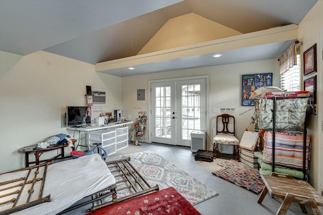 sitting room with lofted ceiling, concrete floors, and french doors