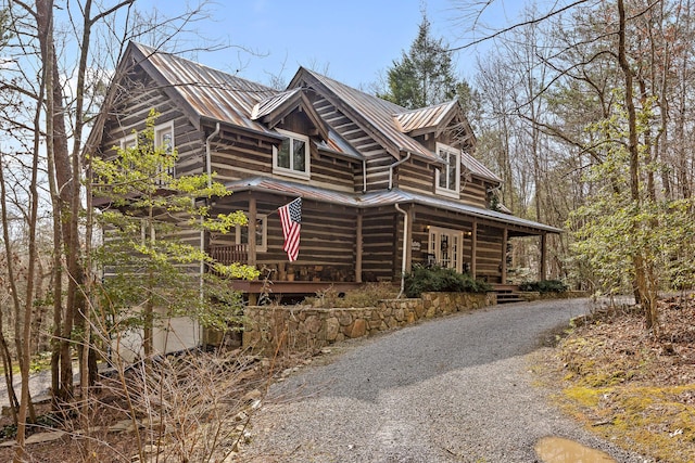 view of side of property with covered porch