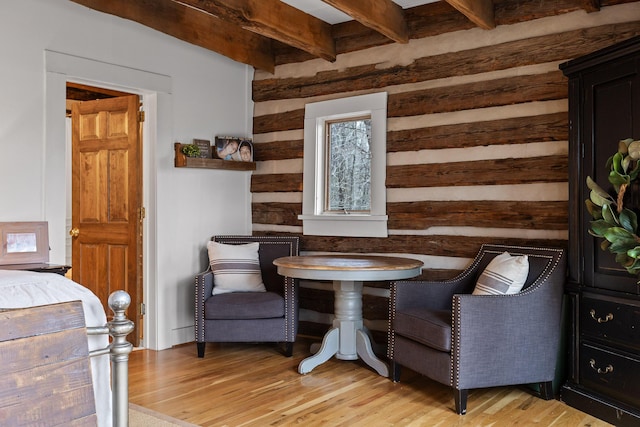 sitting room with beam ceiling and light hardwood / wood-style floors