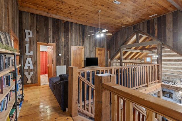 interior space with light wood-type flooring, high vaulted ceiling, wooden walls, and wooden ceiling