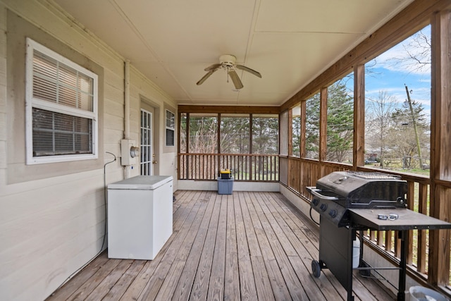 sunroom / solarium featuring plenty of natural light and ceiling fan