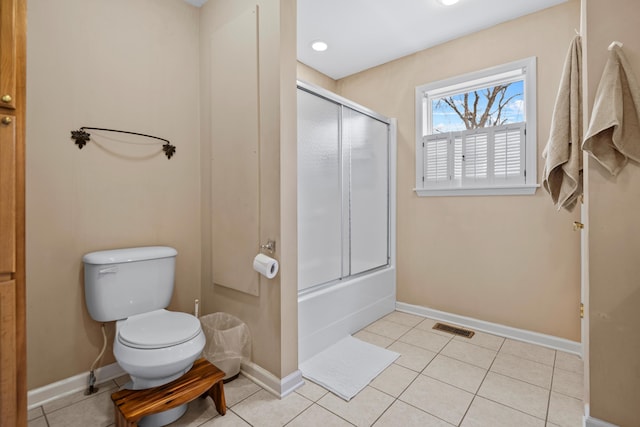 bathroom with tile patterned flooring, toilet, baseboards, and visible vents