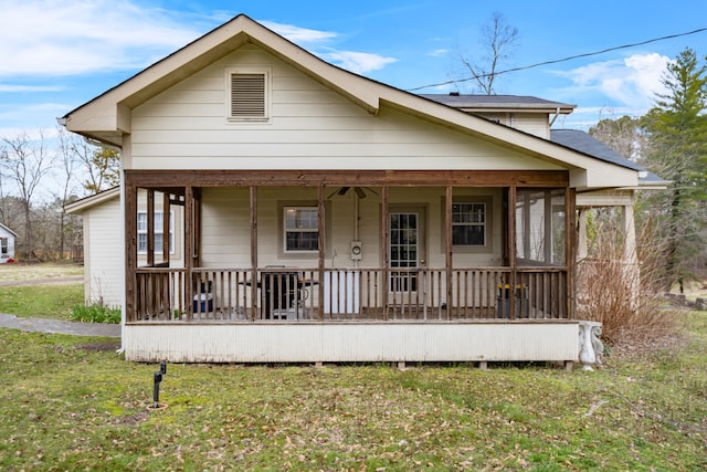 bungalow with a front lawn and covered porch