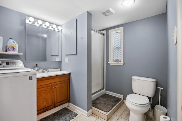 full bath with a shower stall, toilet, vanity, tile patterned floors, and washer / clothes dryer