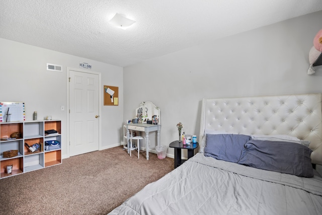 bedroom with visible vents, baseboards, carpet, and a textured ceiling