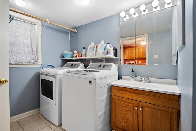 laundry room with a sink, separate washer and dryer, light tile patterned floors, baseboards, and laundry area