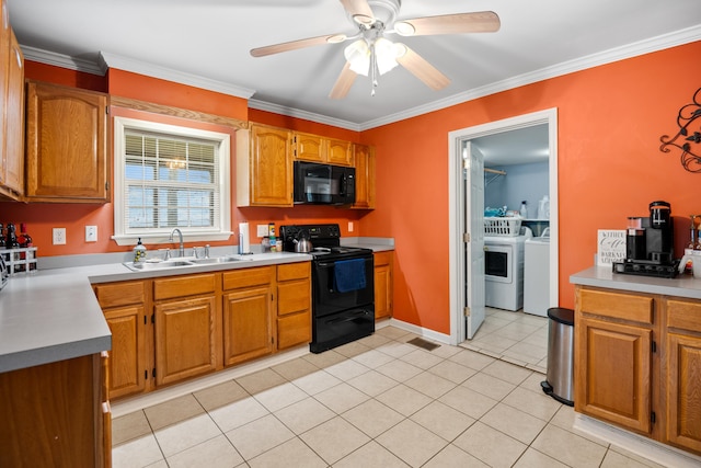 kitchen featuring light tile patterned floors, a ceiling fan, a sink, black appliances, and independent washer and dryer