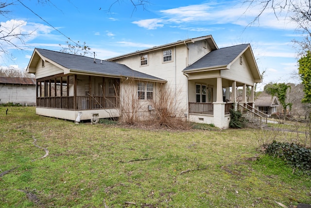 rear view of house with a yard, a porch, stairway, and a sunroom