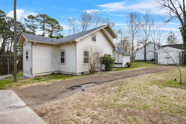 view of home's exterior featuring an outdoor structure and a detached garage