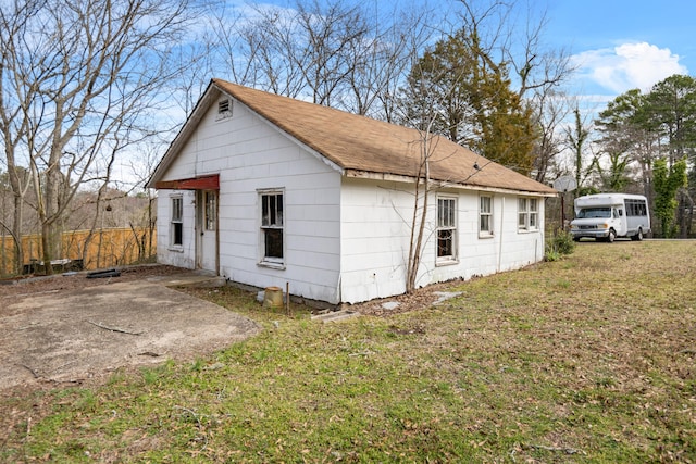 view of side of home featuring a yard