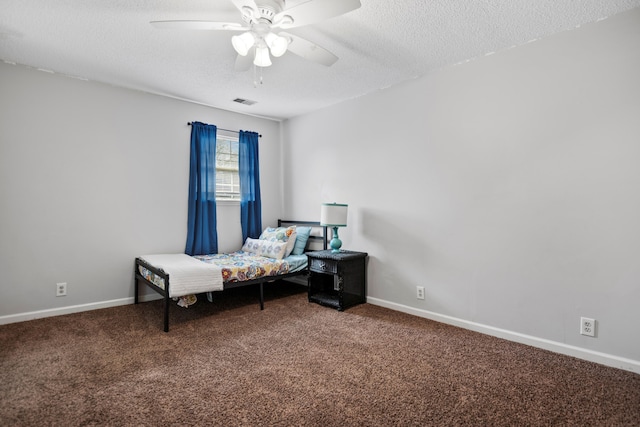 bedroom featuring baseboards, ceiling fan, a textured ceiling, and carpet