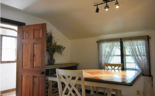 dining room featuring lofted ceiling