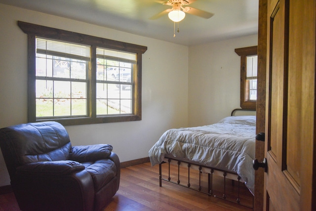 bedroom with dark wood-type flooring and ceiling fan