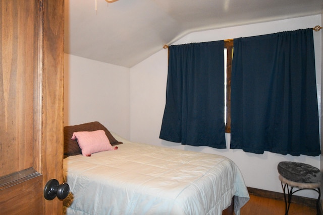 bedroom with wood-type flooring and lofted ceiling