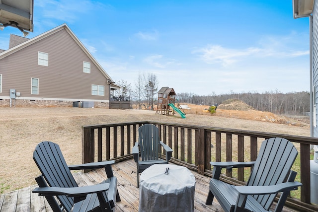 wooden deck featuring area for grilling and a playground