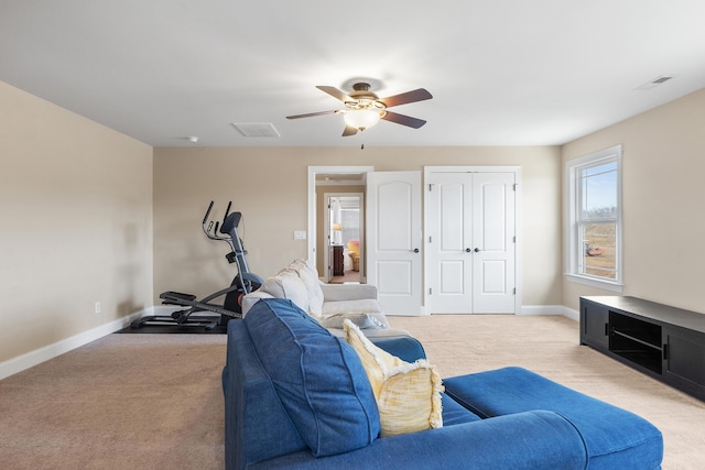 carpeted living room featuring ceiling fan