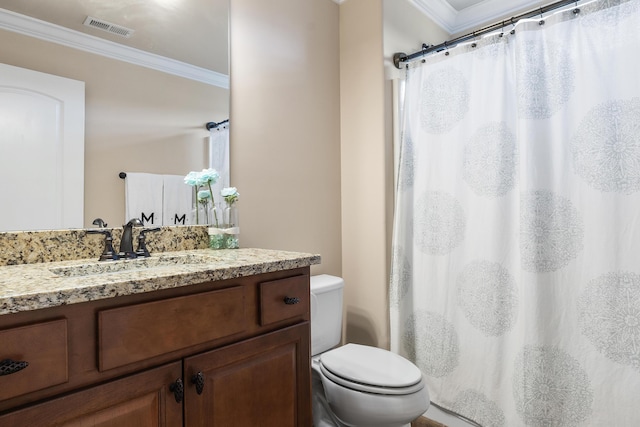 bathroom with ornamental molding, vanity, and toilet