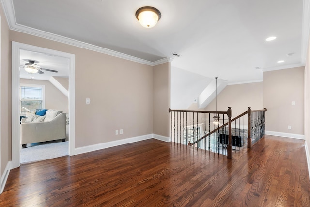 empty room with crown molding, dark hardwood / wood-style floors, and ceiling fan