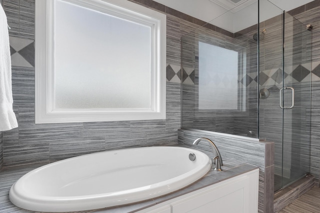 bathroom with shower with separate bathtub