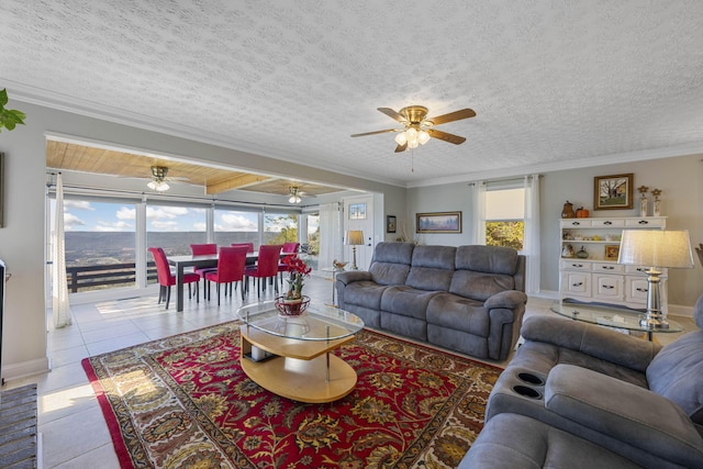 living room featuring light tile patterned floors, crown molding, a textured ceiling, and a water view