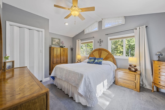 carpeted bedroom with vaulted ceiling, ceiling fan, and a closet