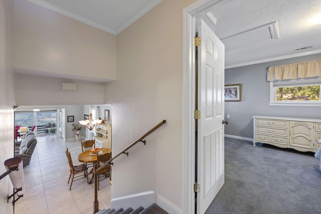 stairs with tile patterned flooring, crown molding, and a textured ceiling