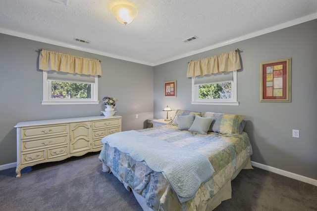 bedroom featuring multiple windows, a textured ceiling, and dark colored carpet