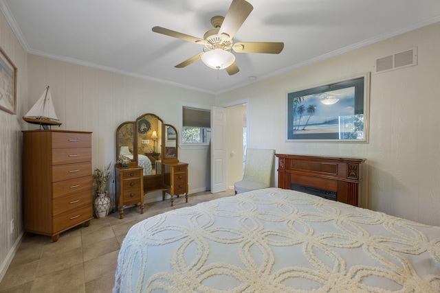 bedroom featuring ceiling fan, ornamental molding, and light tile patterned floors