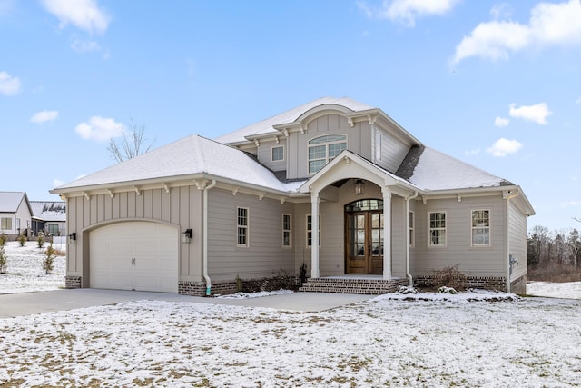 view of front of house featuring board and batten siding, french doors, roof with shingles, and a garage