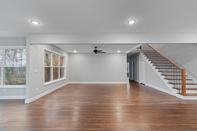 unfurnished living room with ceiling fan and dark hardwood / wood-style flooring