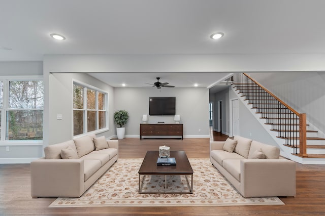 living room featuring hardwood / wood-style floors and ceiling fan