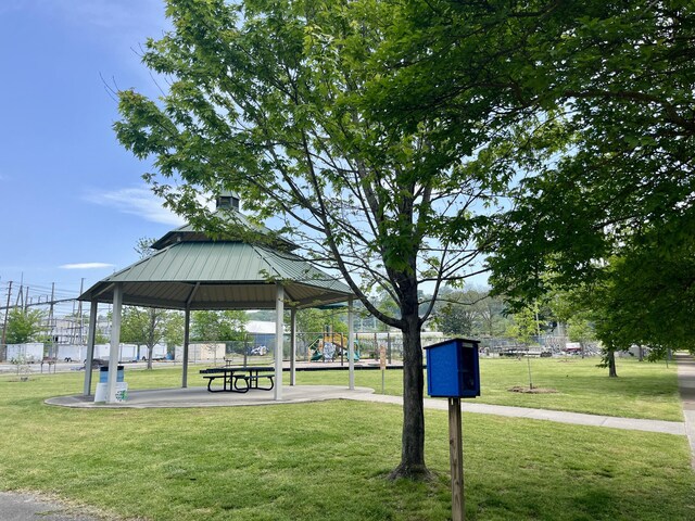 view of property's community with playground community, a lawn, and a gazebo