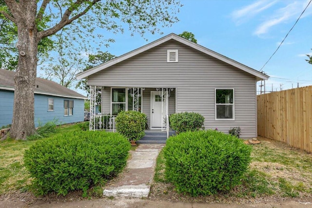 bungalow with fence and covered porch