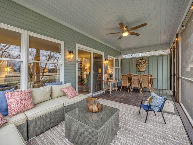 sunroom / solarium featuring wooden ceiling and ceiling fan