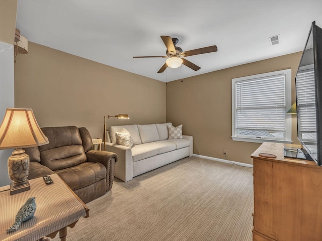 living room featuring light colored carpet and ceiling fan