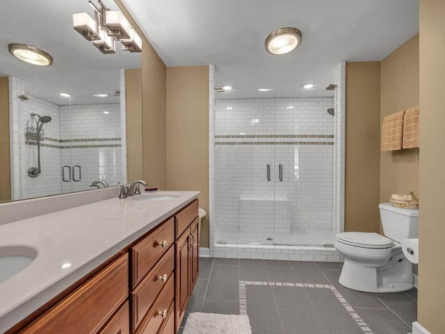 bathroom featuring tile patterned flooring, vanity, a shower with door, and toilet